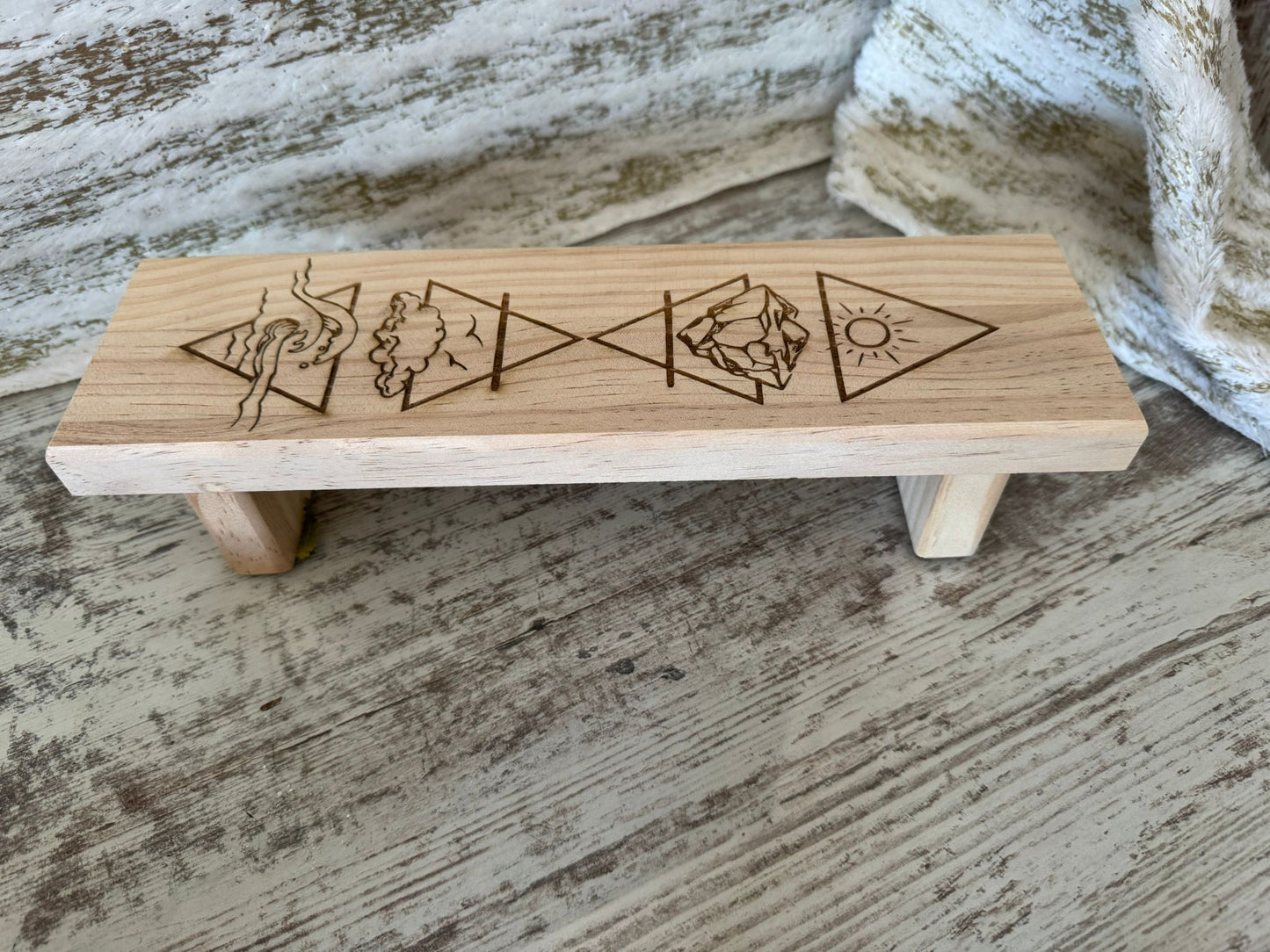 Soporte ritual de madera con símbolos elementales